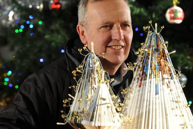 A Christmas tree made of travel brochures was the main attraction at a festival.