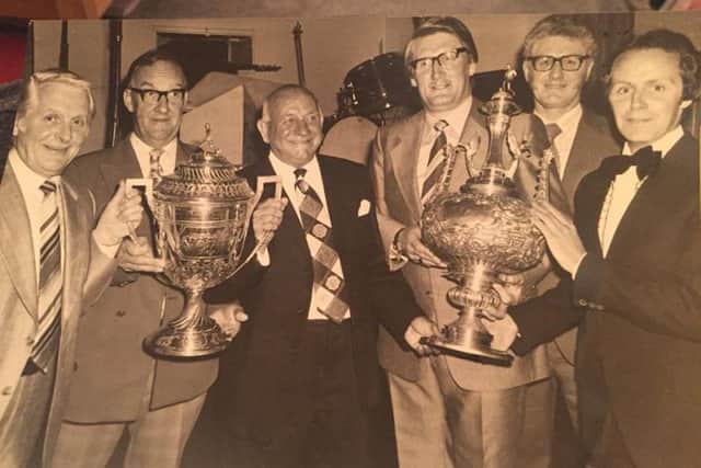 Leyland Motors FC manager Terry Challinor, far right, with a trophy