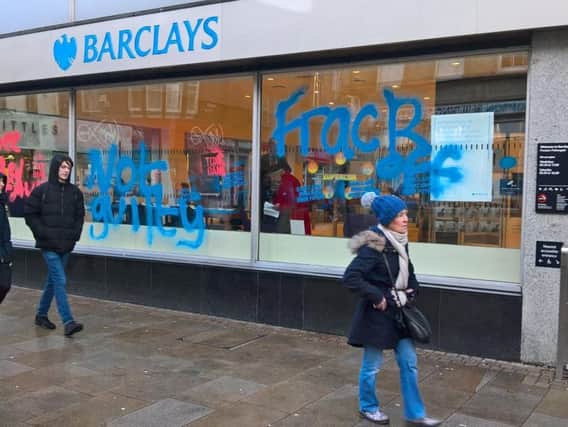 Vandals spray-painted the words Frack off and Not guilty on the glass window of a Barclays bank branch in Preston.