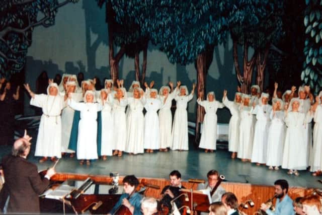 Frank Salter, founder of Preston Opera, conducting the Druid preists and priestesses during a Preston Opera production of Norma at the Charter Theatre in 1984