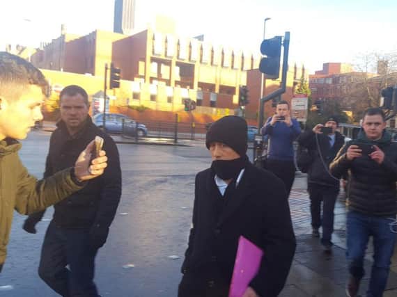 Kieran Creavan (centre) is filmed by a member of the Predator Exposure group (left) outside Leeds Crown Court, where he has admitted sex offences after he was confronted by the so-called paedophile hunters when he travelled to the UK to meet what he thought was a 13-year-old girl. Photo credit: Dave Higgens/PA Wire