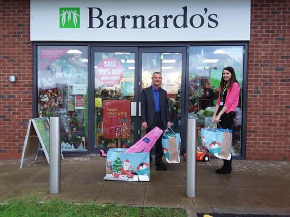 Paul Grime with a member of staff at Barnardos, in Chorley