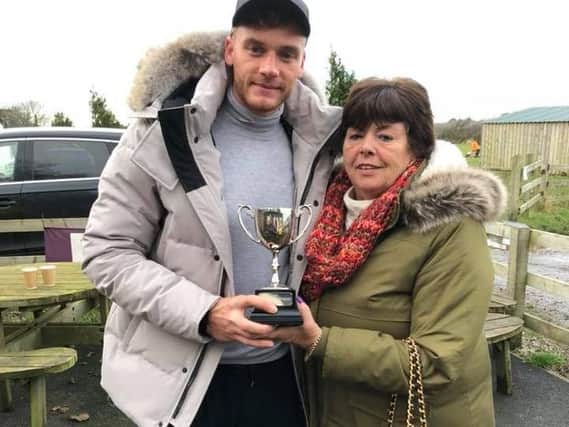 Christine Newsham presenting a trophy to Brett Winstanley, the UK clay pigeon champion at a charity clay shooting event for Jorgie Rae Griffiths