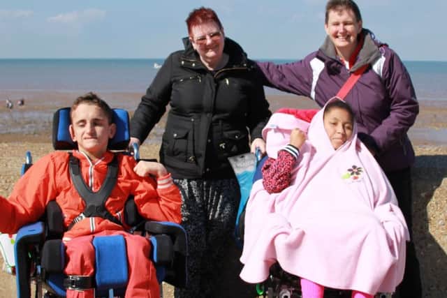 Timmy Pettit, who had cerebral palsy, with parents Barbara, left, and Alison and sister Chelsea