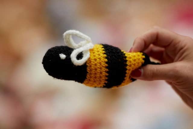 A hand-made knitted bee with some of the 2,000 teddy bears left as tributes to children and others killed in the Manchester Arena bombing