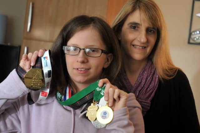 Kim Oosthuizen with her mum Nikki, showing fo the medals she won at the British Transplant Games