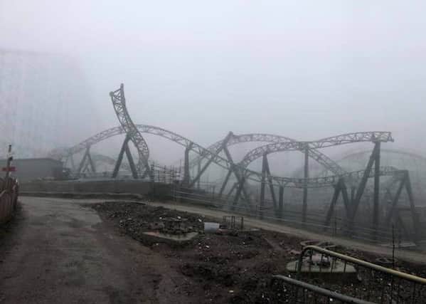A new picture of Blackpool Pleasure Beachs Â£16.25m rollercoaster Icon shows its grey steel track peering eerily through the mist.