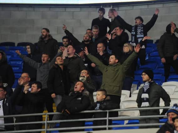 Some of the 372 fans who made the long trip to South Wales celebrate Preston's win.