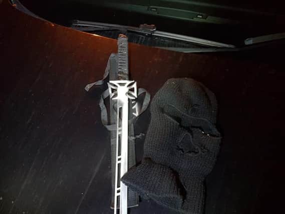 The sword and balaclava found in a car after a police chase. 
Photo: Lancs Roads Police