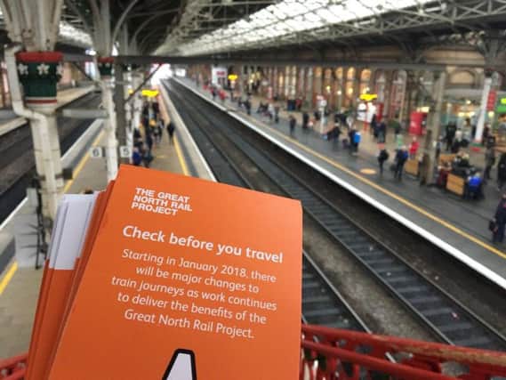 Leaflets are handed out to commuters at Preston station. Photo: Great North Rail Project