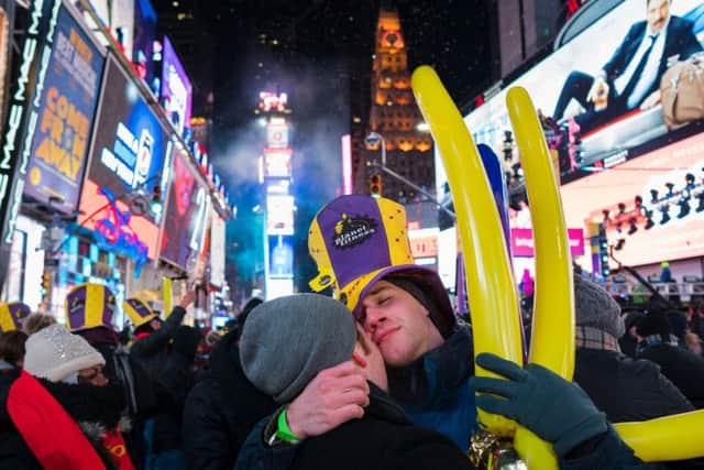 Patrick Graver, right, of New York, embraces Justin Kelly, also of New York, in Times Square