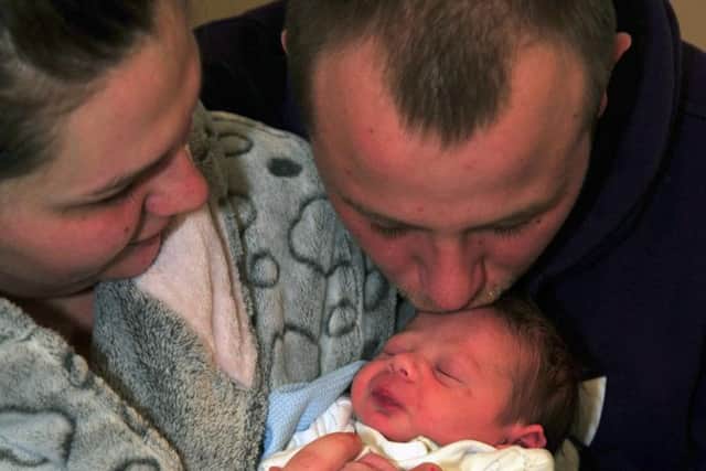 New father David Hough giving his newborn son Aaron-Lee Marcus Hough a kiss.