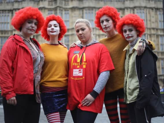 Jess Bower (centre) who was on strike from a McDonald's restaurant in Crayford, south east London, with supporters during a rally at Old Palace Yard