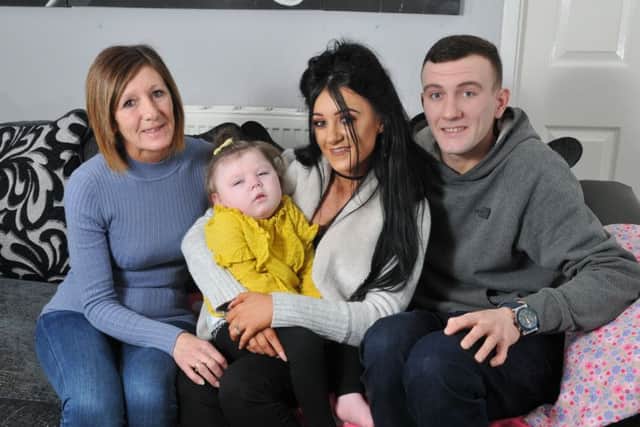 Jenna Heary, 22, and Matthew Botham with their daughter Olivia, two, who has severe epilepsy which means she has over 100 seizures a day, pictured with Jenna's mum Michelle