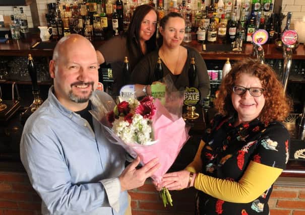 Photo Neil Cross
Michele Bicknell delivering flowers to Tim Tomlinson and the White Cross pub staff after her life was saved by a quick thinking worker