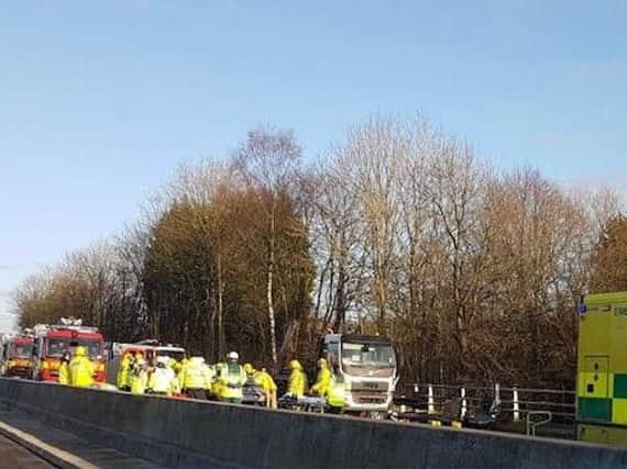 Police, fire crews and paramedics at the scene of the M65 crash this afternoon.
