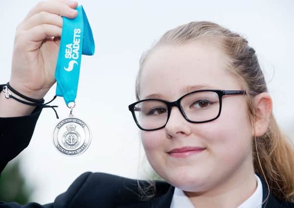 Penwortham Priory Academy student Tiya Sherliker with her swimming medals