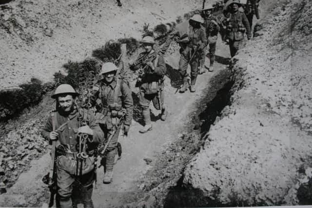 Soldiers from the 1st/4th Battalion Kings Own Royal Lancaster Regiment walk along a support trench on the Somme