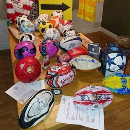 Kevin Shurmer who has MS and has launched the "Balls To MS" campaign to raise money for the Multiple Sclerosis Society
Kevin and his wife with some of the sporting memorabilia and balls he has amassed.