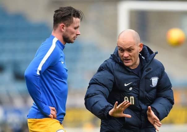Alan Browne gets pre-match instructions from PNE manager Alex Neil at Millwall