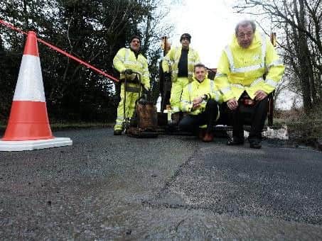 Job done - Watching are highway operatives John Dewhurst  and William Purcell , Phil Durnell LCC head of highways and County Coun Keith Iddon