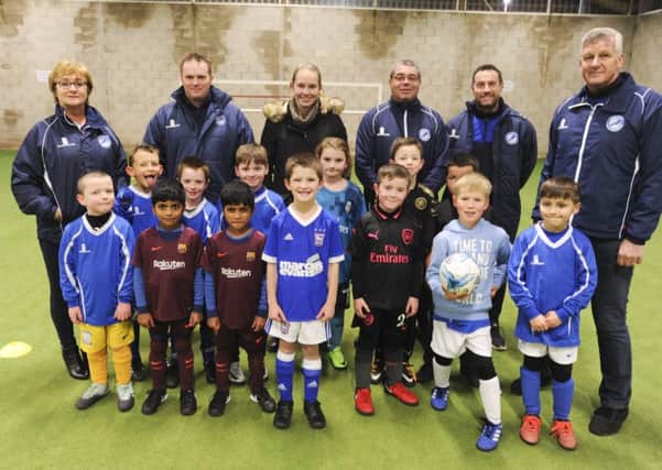 Peter Mason and Kath Mason from the Sir Tom Finney Soccer Centre. They are pictured (far left and far right) with U7s and U8s and their coaches.