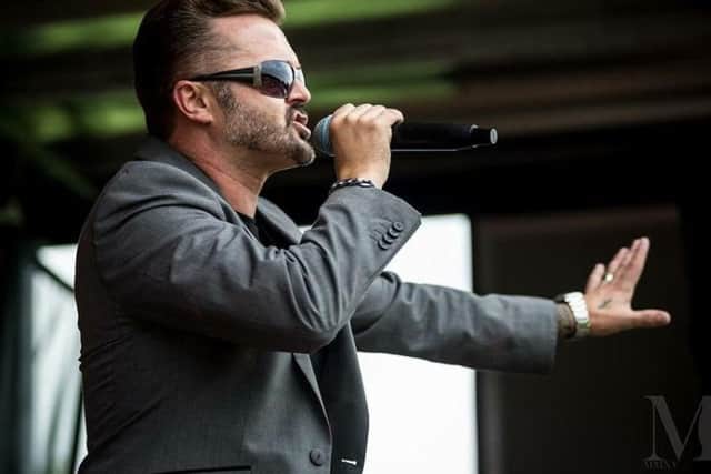 Robert Taylor performs as George Michael. Photo: Mik Connor Photography.