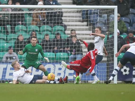 Tom Clarke blocks a shot from Cheikh NDoye