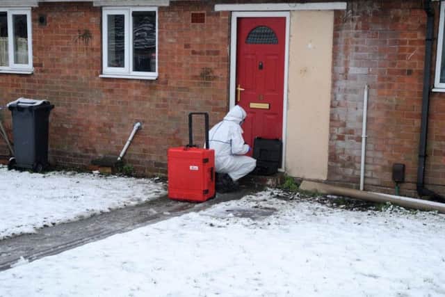 A police forensics officer works outside a property in Brownhills, near Walsall, where a child was discovered seriously wounded on Saturday night and died a short time later in hospital.