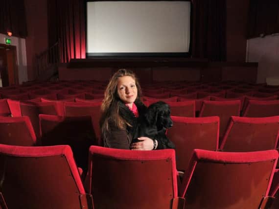 Lara Hewitt preparing for Longridge's Palace Cinema's grand re-opening, with cinema dog Bruce.