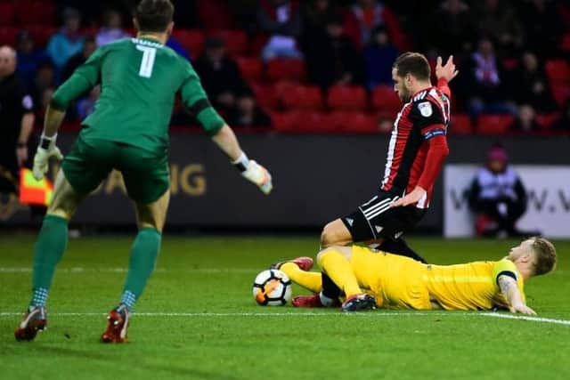 Tom Clarke challenges Billy Sharp for Sheffield United's penalty against PNE