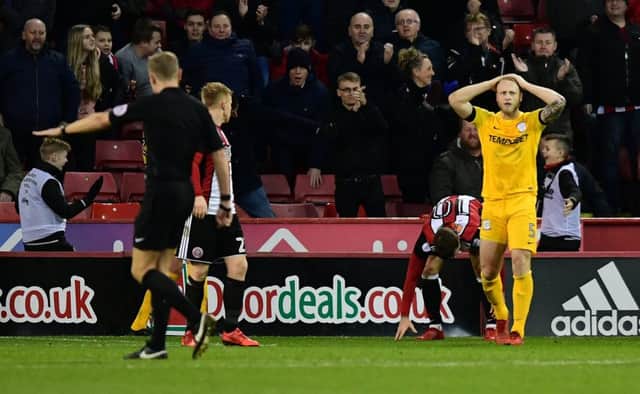 Preston North End's Tom Clarke reacts after referee Graham Scott awards for Sheffield United