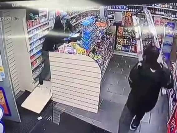 The store worker fends off the raiders with step ladders