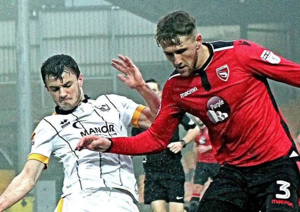 Morecambe's Patrick Brough battles at Vale Park (photos: Mike Williamson)