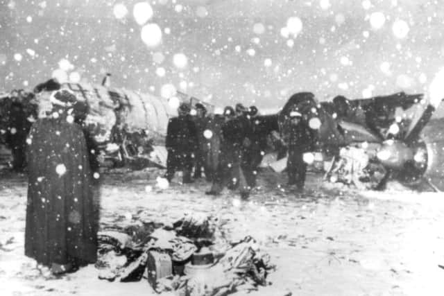 Rescuers and officials search the wreckage of the BEA Elizabethen airliner which crashed on take off from Munich airport