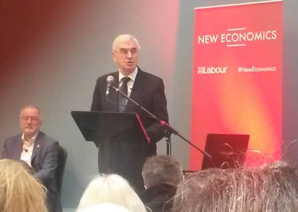 John McDonnell speaking in Preston as city council leader Peter Rankin looks on