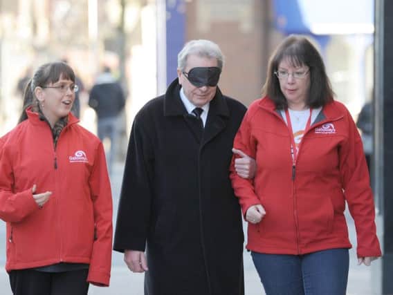 County councillor Keith Iddon is shown around the shared space on Fishergate by Nia Greer and Jenny Lloyd from Galloway's Society for the Blind