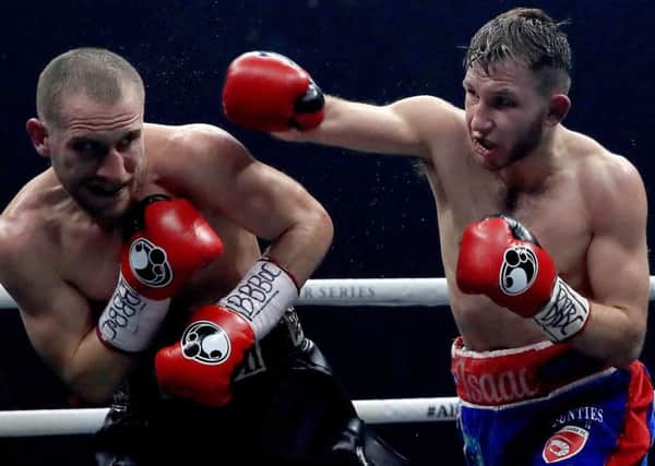 Isaac Lowe (right) on the attack against Ryan Walsh in their British featherweight title at the Manchester Arena