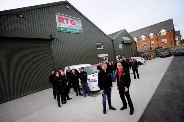 Owner Brian Waring is seen front with his son Lee and the rest of the staff of RTG Automotive