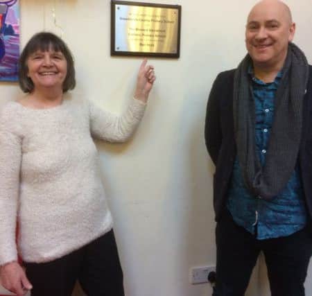 Community volunteer and ray of sunshine organiserTeresa Gettins with Ben Hunt who created the signage for the Sion Community Hub