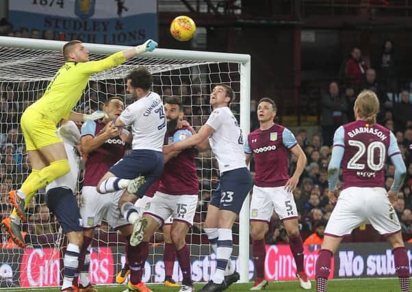 Aston Villa's Sam Johnstone clears a Preston North End attack