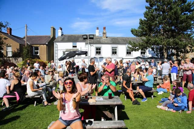 MORECAMBE MUSIC FESTIVAL: People enjoying music in the sun in the Morecambe Hotel beer garden. Photo by Mike Jackson.