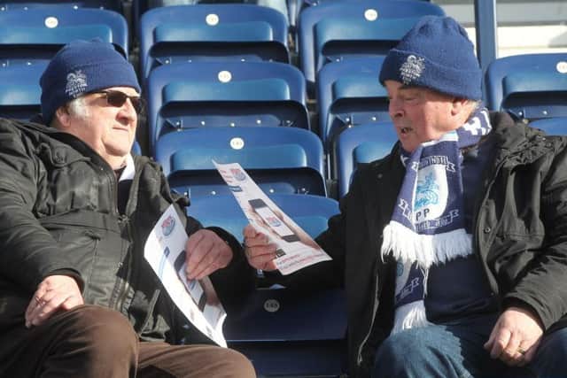Two PNE fans look ahead to the game prior to kick-off.