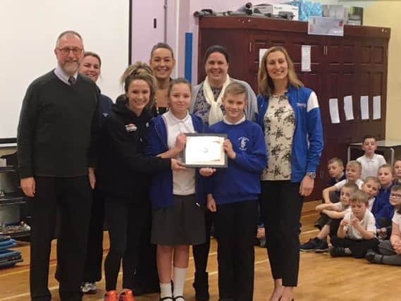 Staff and pupilsat Chorley All Saints Primary Scholo celebrate their Platinum sports mark