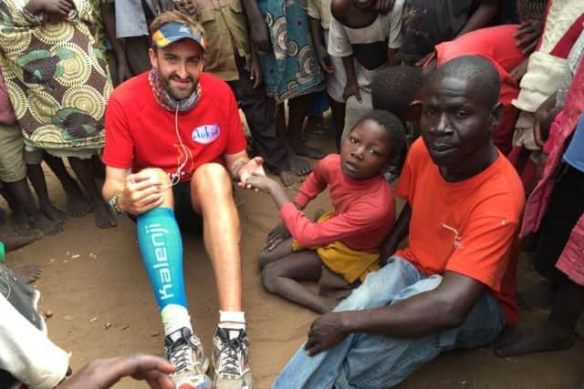 Brendan Rendall with villagers in Malawi in 2016