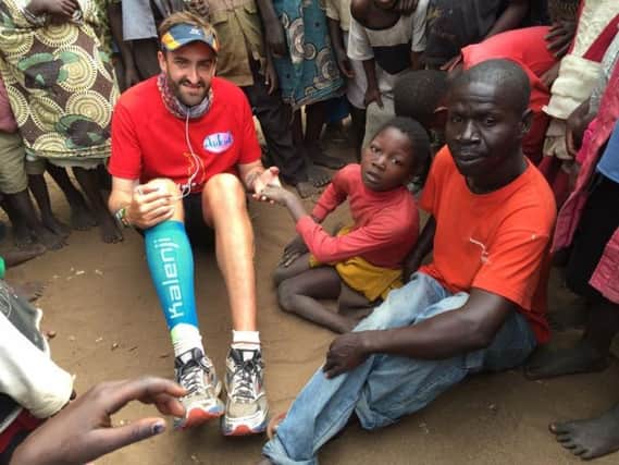 Brendan Rendall with villagers in Malawi in 2016