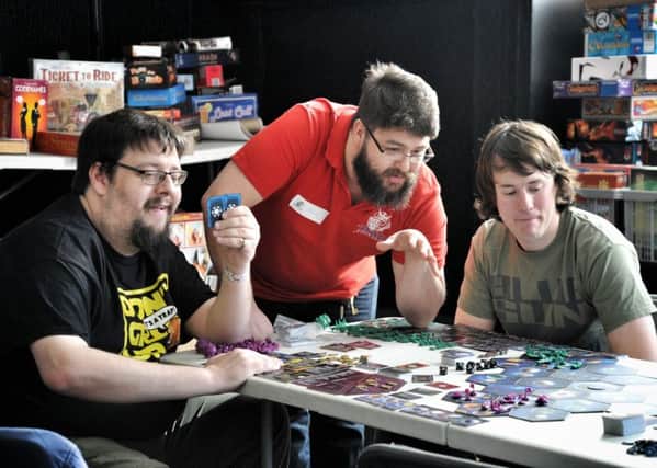 Bradley Cokayne, Dave Kenton and Joe Baldwin  Gamers playing boardgames to raise funds at Royal British Legion Club, Penwortham, Preston