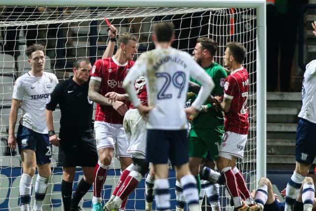 Referee Geoff Eltringham shows Aden Flint the red card against North End