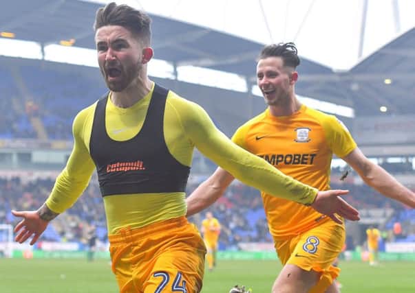 Sean Maguire celebrates scoring his first goal at Bolton, pursued by Alan Browne