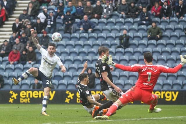 Sean Maguire sees a shot blocked by Ryan Fredericks